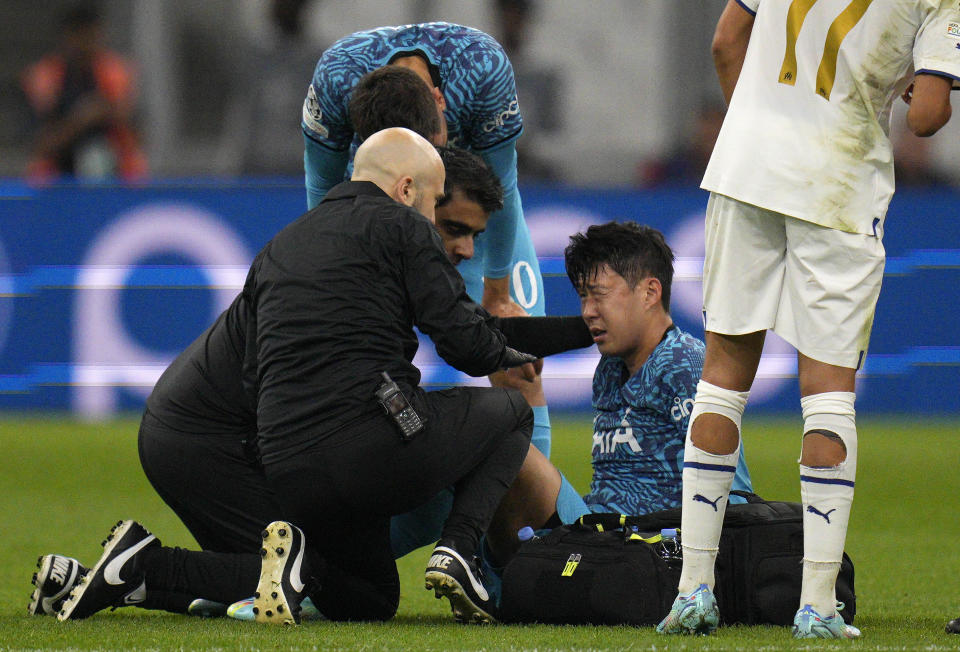 FILE - Tottenham' s Son Heung-min receives treatment after taking a knock during the Champions League Group D soccer match between Marseille and Tottenham Hotspur at the Stade Velodrome in Marseille, France, Tuesday, Nov. 1, 2022. When Son Heung-min went down clutching his face in Tottenham’s Champions League match with Marseille last week the pain was not confined to his fractured eye socket. The shockwaves were felt all the way back in his homeland South Korea as the nation feared the worst ahead of the World Cup. (AP Photo/Daniel Cole, File)