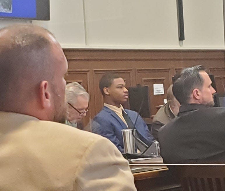 Christopher Blue looks on as prosecutors give their closing arguments Thursday in Blue's trial in the murder of Owen Barzal in October 2021. In the foreground at left is Matthew Barzal, the victim's father. Seated at Blue's right is defense attorney Charles Quinn. At right is Akron police Sgt. Gregory Moenich, who was the sergeant in charge of the investigation.