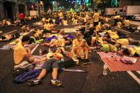 Protestors rest and sleep on a road before dawn on the second day of a demonstration demanding Prime Minister Najib Razak’s resignation and electoral reforms in Kuala Lumpur on August 30, 2015