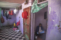 In this in Wednesday, March 25, 2020 photo, Abderrazak Abdelhady, 66, sits in his room in an overcrowded housing complex in Sale, near Rabat, Morocco. Hundreds of people live in crowded rooms in this Moroccan housing complex with no running water and no income left because of the coronavirus lockdown measures. However volunteers come to help clean as the government tries to protect the population from virus while not punishing the poor. (AP Photo/Mosa'ab Elshamy)