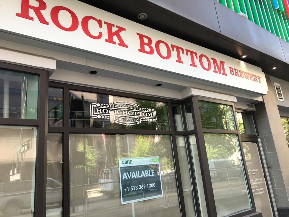 A leasing company sign and paper cover the windows Tuesday at Fountain Square fixture Rock Bottom Brewery on Sixth Street in Cincinnati.