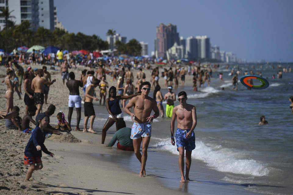 A general view of people partying on Fort Lauderdale Beach as Spring break crowds draw a concern during critical moment in the COVID-19 pandemic on March 14, 2021 in Fort Lauderdale, Florida. (mpi04/MediaPunch /IPX via AP)