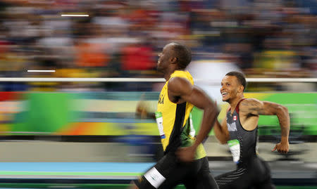 FILE PHOTO: 2016 Rio Olympics - Athletics - Semifinal - Men's 200m Semifinals - Olympic Stadium - Rio de Janeiro, Brazil, August 17, 2016. Usain Bolt (JAM) of Jamaica and Andre De Grasse (CAN) of Canada smile as they compete. REUTERS/Phil Noble/File Photo