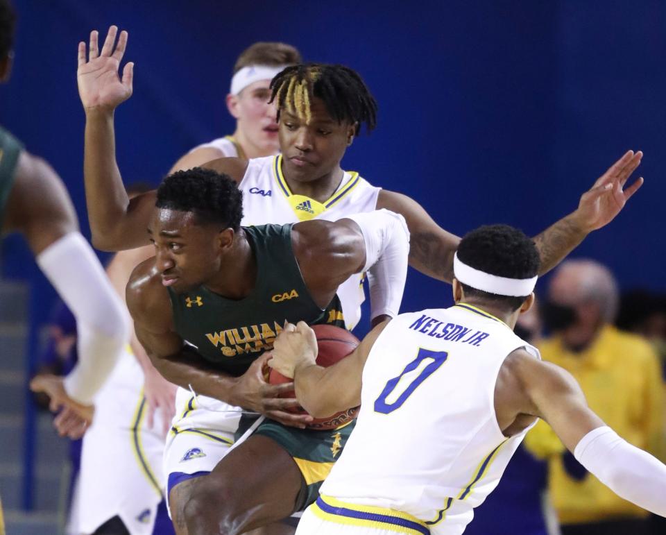 Delaware's Jyare Davis (top) and Jameer Nelson, Jr., defend as William and Mary's Brandon Carroll in the first half of Delaware's 84-74 win at the Bob Carpenter Center, Thursday Jan. 20, 2022.