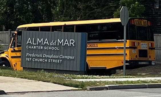 In this photo a school bus drives onto the Alma del Mar Charter School's Frederick Douglass Campus. The complaint under investigation was made by Leida Rodrigues in June after a video taken by another student was posted in which her 10-year-old son was slapped twice in the face by an older boy on a school bus.