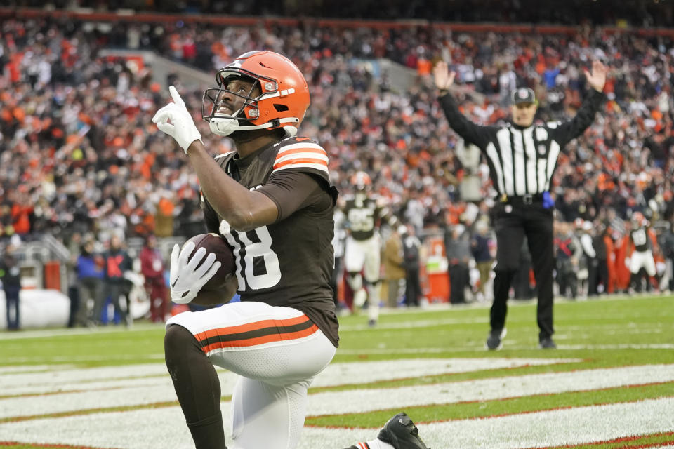 Cleveland Browns wide receiver David Bell (18) knees and looks skyward after running for a 41-yard touchdown during the second half of an NFL football game against the Jacksonville Jaguars, Sunday, Dec. 10, 2023, in Cleveland. (AP Photo/Sue Ogrocki)