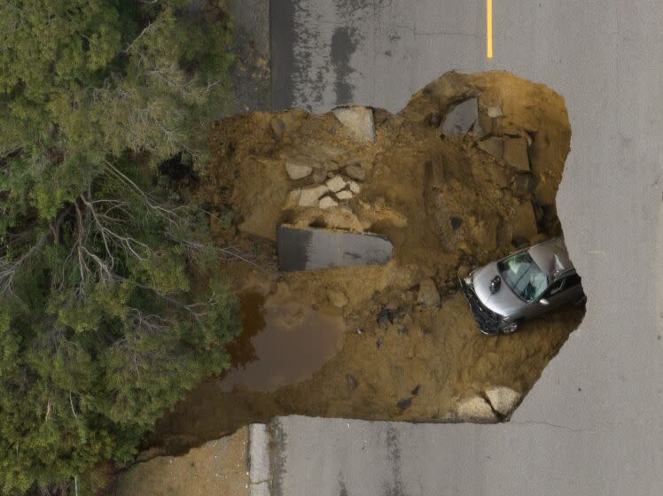 CHATSWORTH, CA - JANUARY 10: Two vehicles fell into a sinkhole on Iverson Road in Chatsworth trapping four people. Photographed at Iverson Road on Tuesday, Jan. 10, 2023 in Chatsworth, CA. (Myung J. Chun / Los Angeles Times)