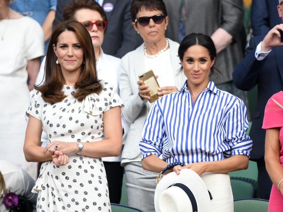 Catherine, Duchess of Cambridge and Meghan, Duchess of Sussex attend day twelve of the Wimbledon Tennis Championships at the All England Lawn Tennis and Croquet Club on July 14, 2018