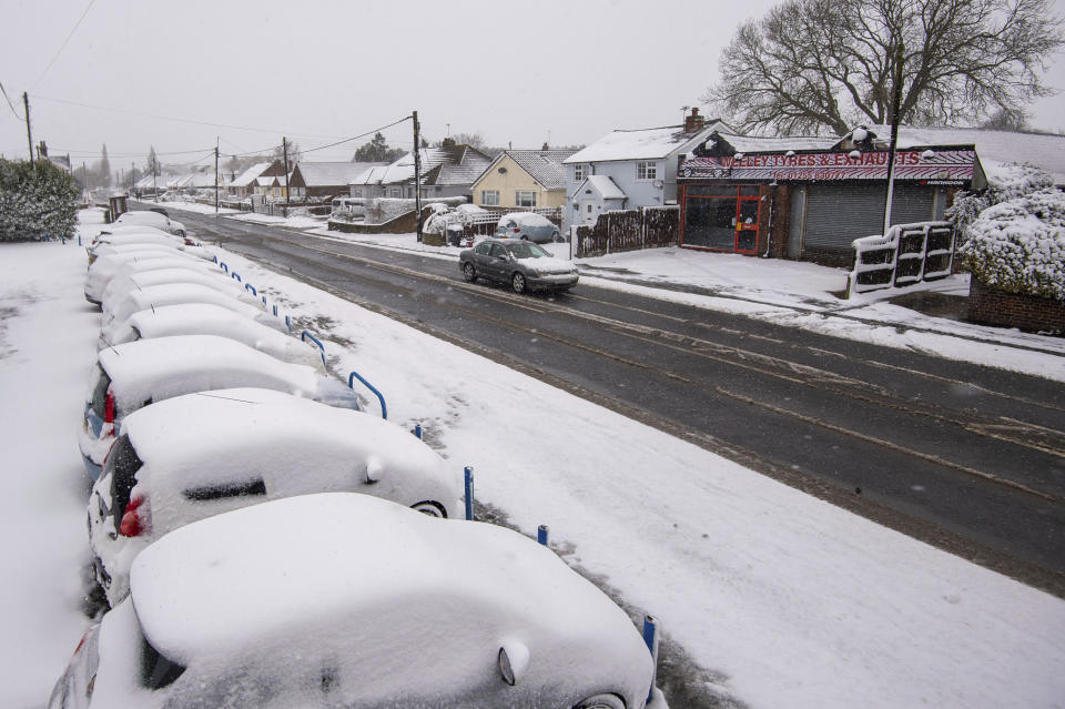 Cars covered in snow at a car dealership in Weeley, southern England, Sunday Feb. 7, 2012. Heavy snow is predicted to bring travel disruption to south-east England as bitterly cold winds grip much of the nation.(Joe Giddens/PA via AP)