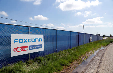 FILE PHOTO: A Foxconn logo is seen before the arrival of U.S. President Donald Trump as he participates in the Foxconn Technology Group groundbreaking ceremony for its LCD manufacturing campus, in Mount Pleasant, Wisconsin, U.S., June 28, 2018. REUTERS/Darren Hauck/File Photo