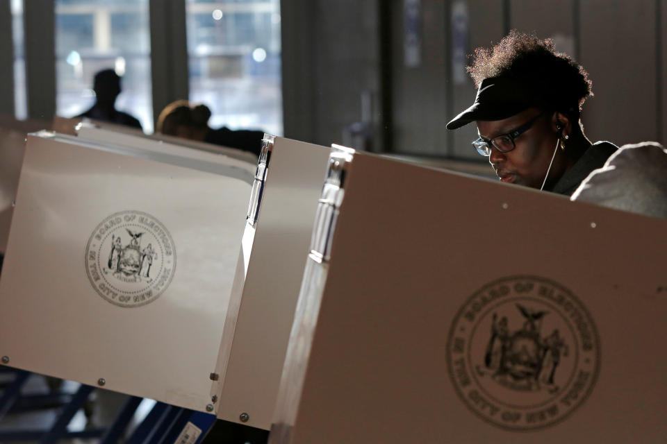 A woman fills out a ballot for the U.S presidential election at the James Weldon Johnson Community Center in the East Harlem neighborhood of Manhattan, New York City, on Nov. 8.