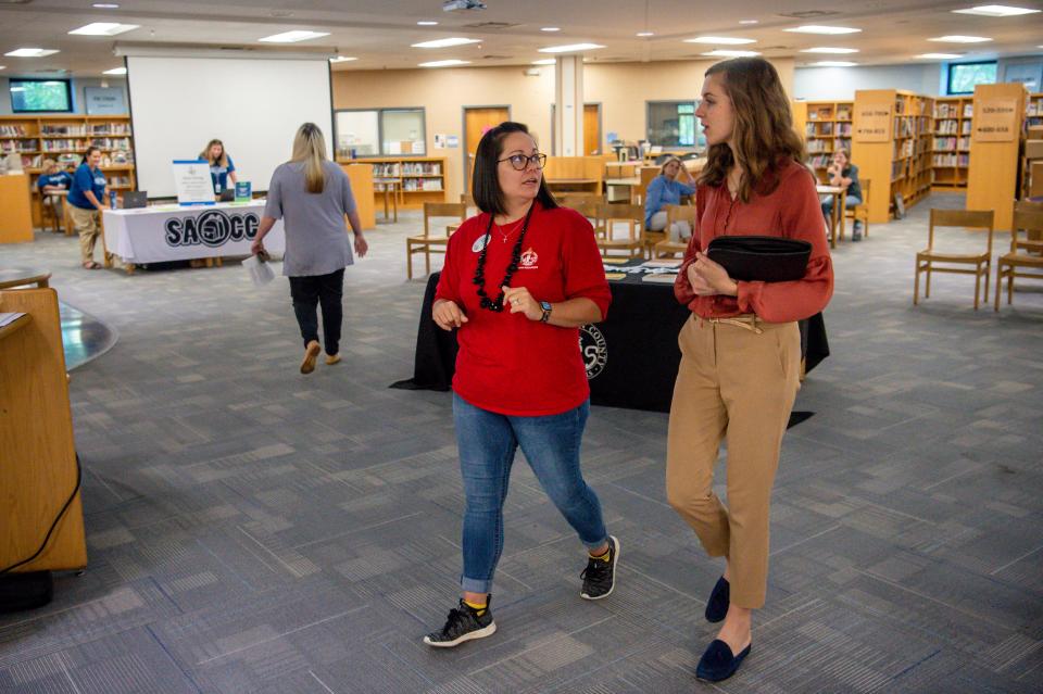 Katie Wells of Williamson County Schools Human Resources walks and talks with Maci Flannery of Spring Hill during a job fair for open classified positions in the school district on Friday, July 23, 2021 held at Centennial High School in Franklin, Tenn.