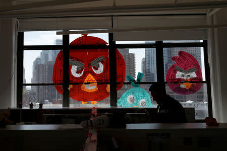 Images of Angry Birds created with Post-it notes are seen on a window created with Post-it notes at the Horizon Media offices at 75 Varick Street in lower Manhattan, New York, May 18, 2016. REUTERS/Mike Segar
