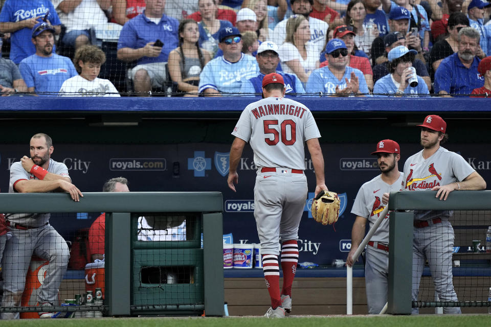 St. Louis Cardinals starting pitcher Adam Wainwright walks to the dugout after coming out of the baseball game against the Kansas City Royals during the second inning Friday, Aug. 11, 2023, in Kansas City, Mo. (AP Photo/Charlie Riedel)