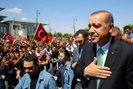 Turkish President Tayyip Erdogan greets his supporters following the Friday prayers in Ankara, Turkey, July 22, 2016. Kayhan Ozer/Presidential Palace/Handout via REUTERS