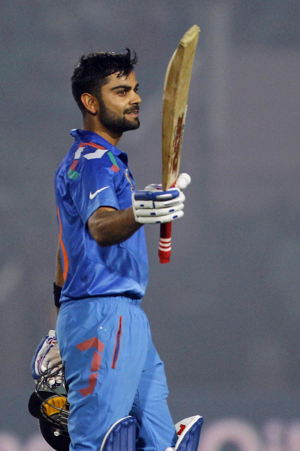 India’s Virat Kohli acknowledges the crowd after scoring a century during the Asia Cup one-day international cricket tournament against Bangladesh in Fatullah, near Dhaka, Bangladesh, Wednesday, Feb. 26, 2014. (AP Photo/A.M. Ahad)