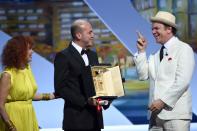 Colombian director Cesar Augusto Acevedo (C) accepts his Camera d'Or from French actress Sabine Azema (L) and US actor John C. Reilly