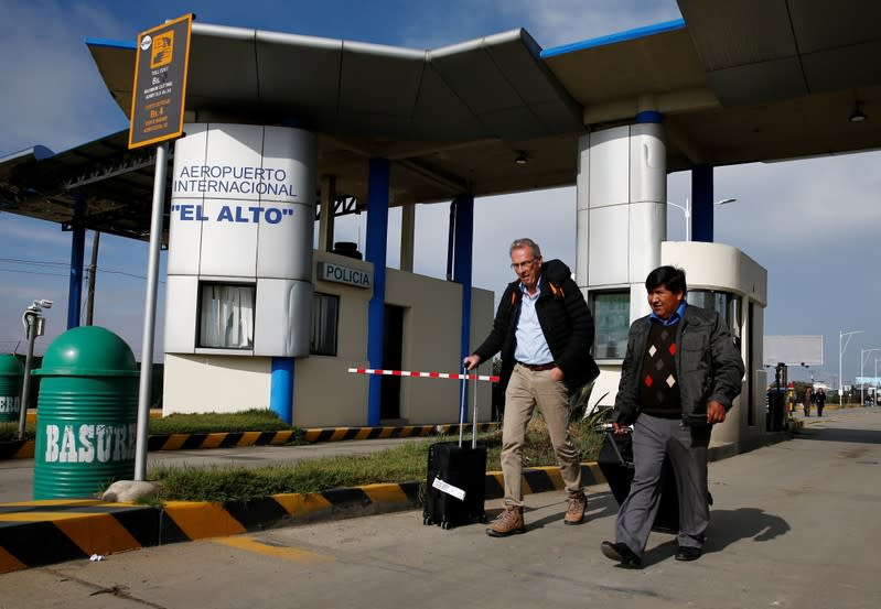 A passenger leaves the El Alto airport after supporters of Bolivia's President Evo Morales entered the airport to protest against Luis Fernando Camacho, President of Civic Committee of Santa Cruz, on the outskirts of La Paz