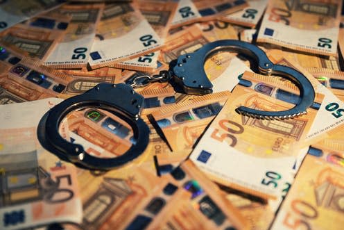   <span class="attribution"><a class="link " href="https://www.shutterstock.com/image-photo/financial-crime-concept-handcuffs-on-cash-1502322098" rel="nofollow noopener" target="_blank" data-ylk="slk:ronstik / shutterstock.com;elm:context_link;itc:0;sec:content-canvas">ronstik / shutterstock.com</a></span>