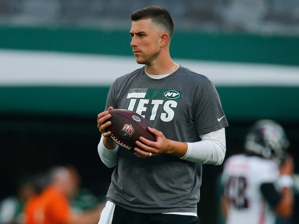 Mike White holds the ball and looks on before a Jets preseason game in 2022.