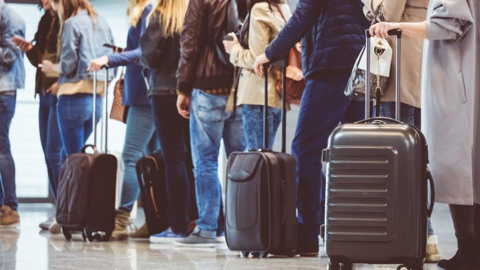 Group of people standing in queue at boarding gate