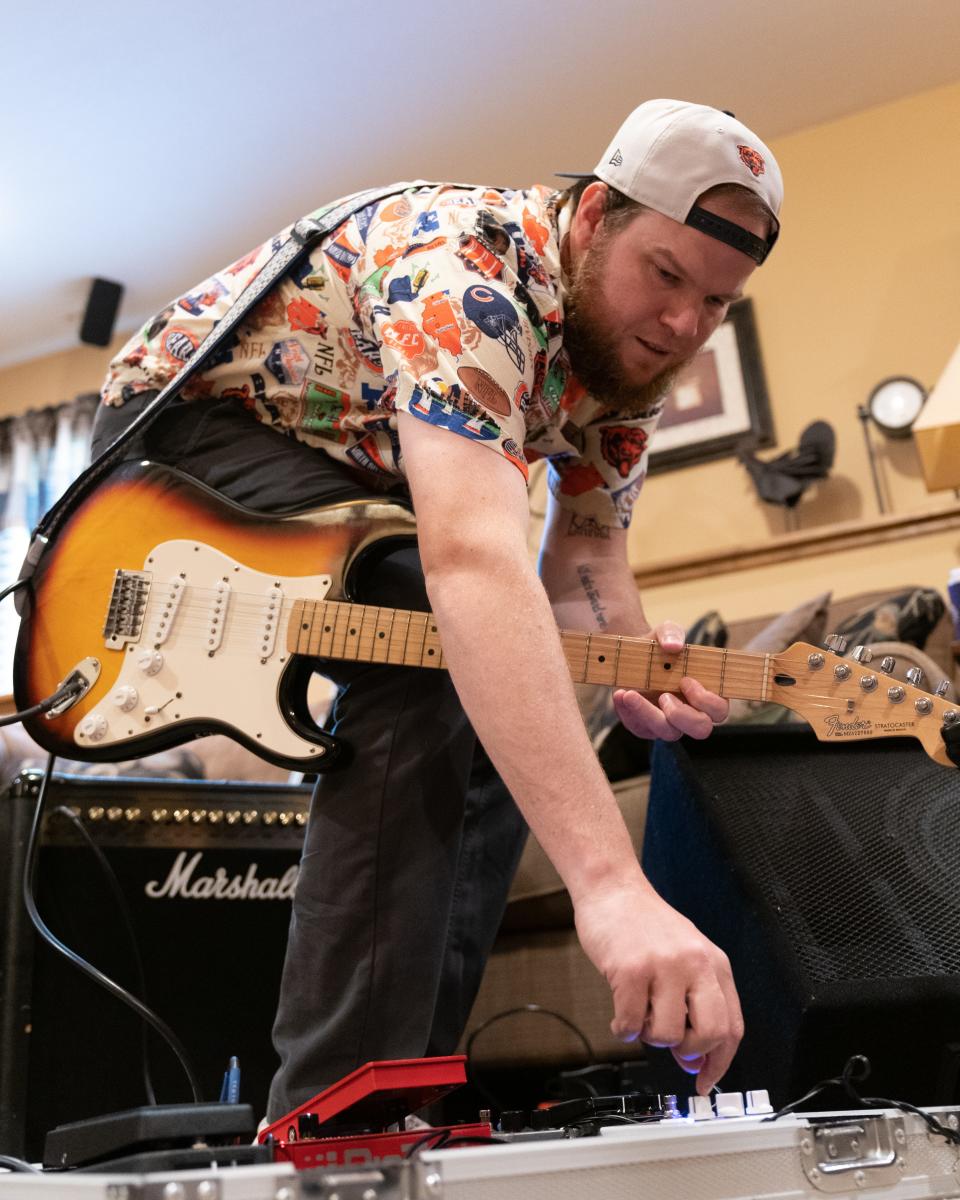 Untamed Mustangz guarist Ryan Bach adjusts an effects pedal before starting practice Tuesday afternoon.