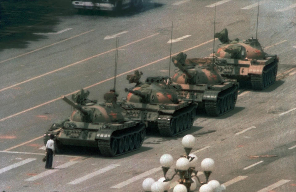 A Chinese man stands alone to block a line of tanks heading east on Beijing's Cangan Blvd. in Tiananmen Square on June 5, 1989. The man, calling for an end to the recent violence and bloodshed against pro-democracy demonstrators, was pulled away by bystanders, and the tanks continued on their way. | Jeff Widener—AP