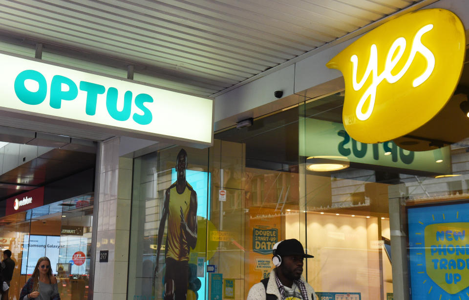 A man walks past an Optus store in Sydney on Tuesday, March 22, 2016. (AAP Image/Mick Tsikas)