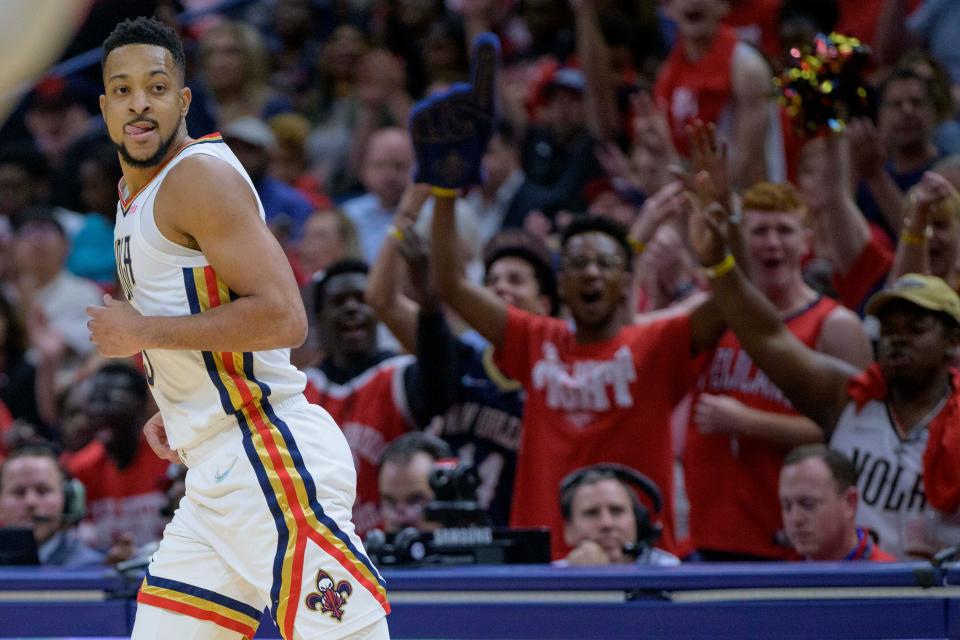 Pelicans guard CJ McCollum celebrates after a 3-point basket against the Phoenix Suns in the first half of Game 4 of an NBA first-round playoff series in New Orleans, Sunday, April 24, 2022. (AP Photo/Matthew Hinton)