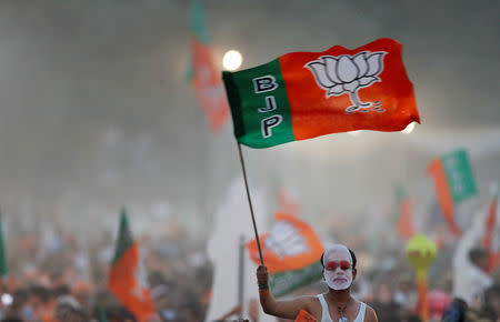 A supporter of India's ruling Bharatiya Janata Party (BJP) waves the party flag during an election campaign rally being addressed by India's Prime Minister Narendra Modi in New Delhi, India, May 8, 2019. REUTERS/Adnan Abidi