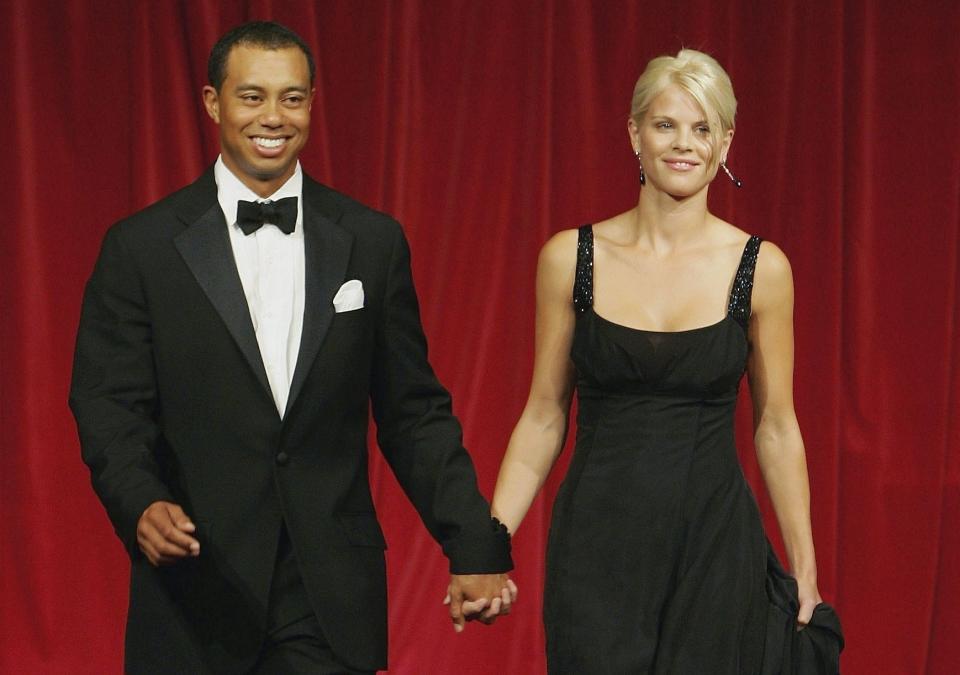Tiger Woods and his wife Elin walk down the catwalk during the Ryder Cup Gala Dinner