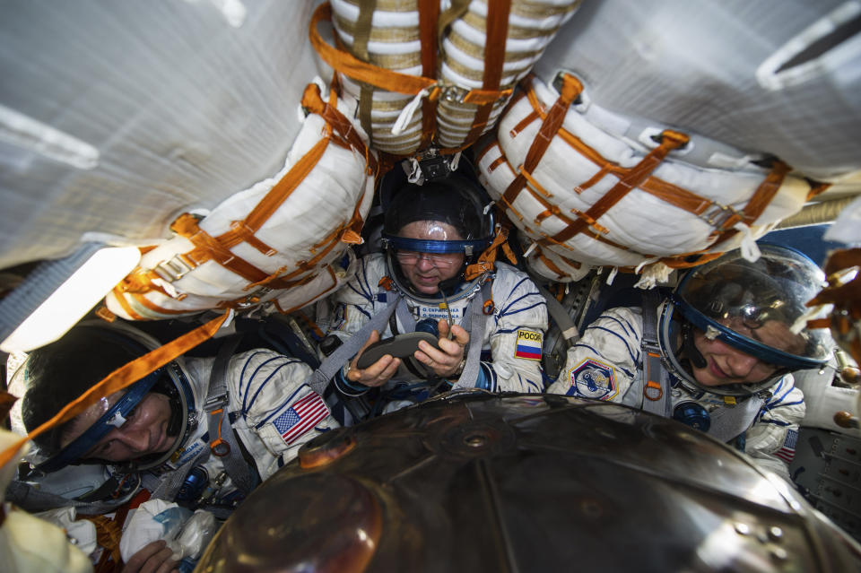 In this photo released by Gagarin Cosmonaut Training Centre (GCTC), Roscosmos space agency U.S. astronauts Andrew Morgan, left, Jessica Meir, right, and Russian cosmonaut Oleg Skripochka sit in the capsule shortly after the landing of the Russian Soyuz MS-15 space capsule near Kazakh town of Dzhezkazgan, Kazakhstan, Friday, April 17, 2020. The International Space Station crew has landed safely after more than 200 days in space. The Soyuz capsule carrying NASA astronauts Andrew Morgan, Jessica Meir and Russian space agency Roscosmos' Oleg Skripochka touched down on Friday on the steppes of Kazakhstan. (Andrey Shelepin, Gagarin Cosmonaut Training Centre (GCTC), Roscosmos space agency, via AP)