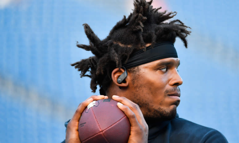 Cam Newton warms up before a game against the Patriots.