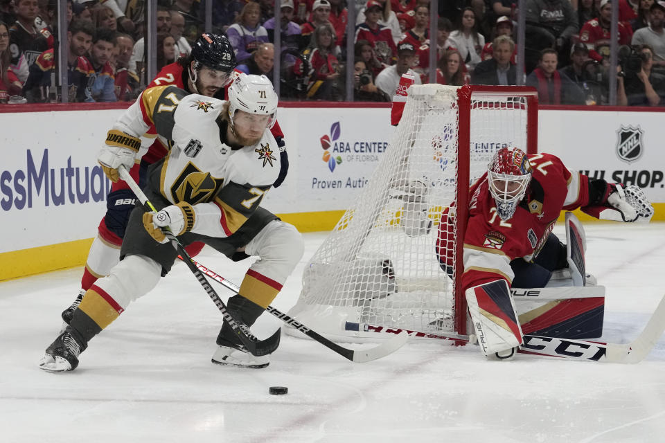 Vegas Golden Knights center William Karlsson (71) skates with the puck as Florida Panthers defenseman Josh Mahura defends during the first period of Game 3 of the NHL hockey Stanley Cup Finals, Thursday, June 8, 2023, in Sunrise, Fla. (AP Photo/Lynne Sladky)