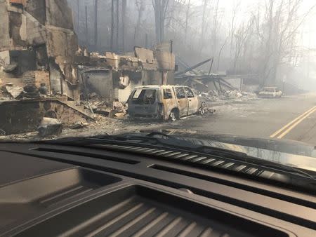 Burned buildings and cars aftermath of wildfire is seen in this image released in social media by Tennessee Highway Patrol in Gatlinburg, Tennessee, U.S. on November 29, 2016. Courtesy Tennessee Highway Patrol/Handout via REUTERS