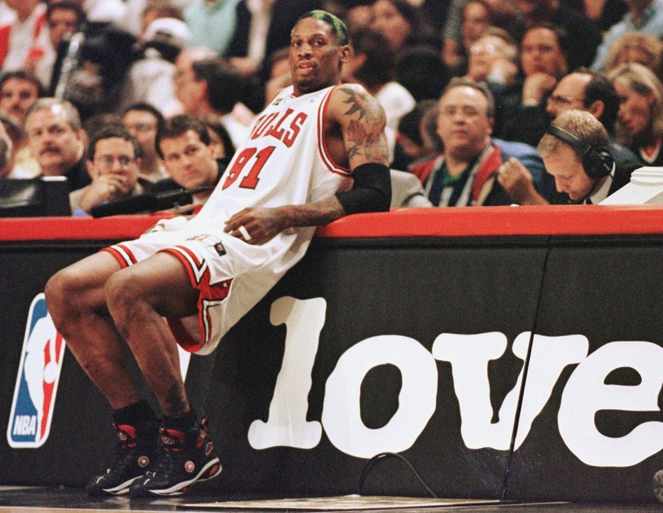 Rodman leans on the scorers' table as he waits to come into the game against the Utah Jazz in game four of the NBA Finals on June 10, 1998. (Photo: JEFF HAYNES/AFP via Getty Images)