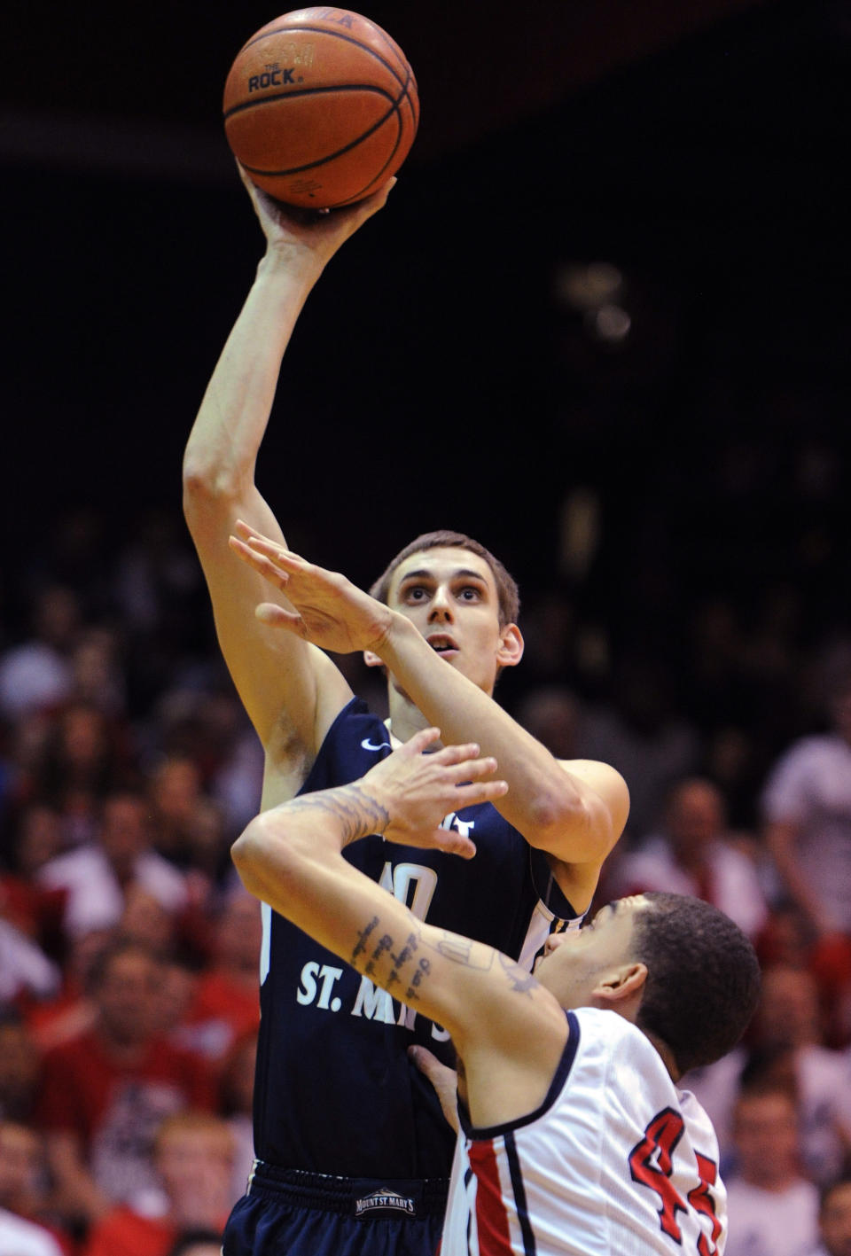 Mount St. Mary's' Taylor Danaher shoots over Robert Morris' Stephan Hawkins (45) during the first half of the Northeastern Conference championship NCAA college basketball game on Tuesday, March 11, 2014, in Coraopolis, Pa. (AP Photo/Don Wright)