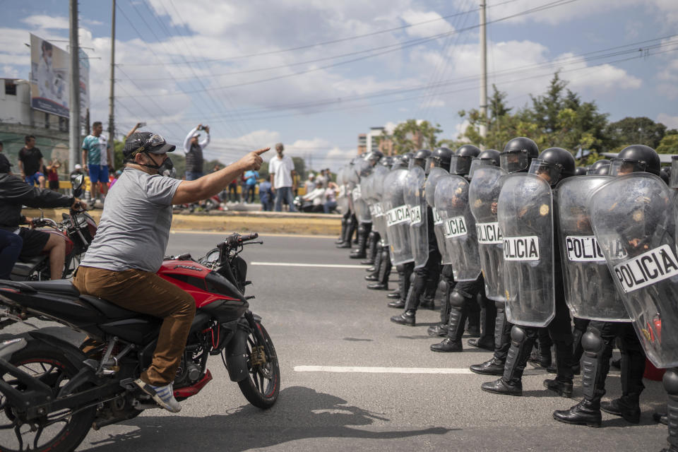 FILE - A demonstrator confronts the police during a national strike, in Guatemala City, Oct. 10, 2023. People were protesting in support of President-elect Bernardo Arévalo after Guatemala's highest court upheld a move by prosecutors to suspend his political party over alleged voter registration fraud. (AP Photo/Santiago Billy, File)