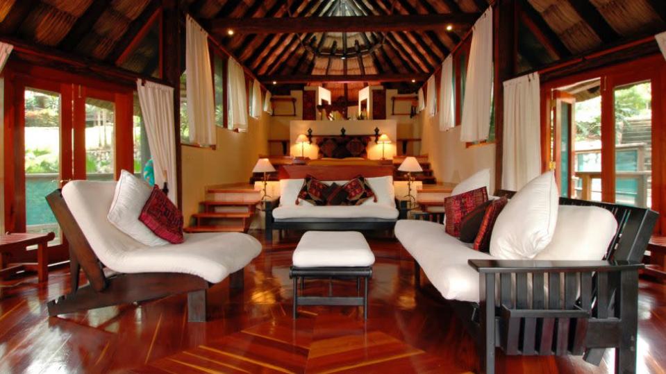 <b>NAME</b>: Chaa Creek<br><b>PLACE</b>: San Ignacio, Cayo<br><b>PRICE</b>: CAD$215<br><br> Nights are a relaxed and peaceful affair. A preprandial with guests over rum and fruit juice, then head to the Chaa Creek restaurant for an eclectic and delicious dinner overlooking the darkening jungle. Then it's back to your beautifully furnished, palm-thatched cottage, perhaps for a Jacuzzi for two, certainly for a blissful sleep. (Image courtesy of <a href="http://www.kiwicollection.com/" rel="nofollow noopener" target="_blank" data-ylk="slk:Kiwi Collection;elm:context_link;itc:0;sec:content-canvas" class="link ">Kiwi Collection</a>.)