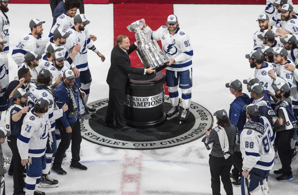 Tampa Bay Lightning's Steven Stamkos (91) is presented the Stanley Cup from NHL commissioner Gary Bettman as they celebrate after defeating the Dallas Stars in the NHL Stanley Cup hockey finals, in Edmonton, Alberta, on Monday, Sept. 28, 2020. (Jason Franson/The Canadian Press via AP)