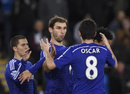 Chelsea's Oscar (R), Branislav Ivanovic (C) and Eden Hazard celebrate after team-mate Andre Schurrle scored a goal during their English Premier League soccer match against Swansea City at the Liberty Stadium in Swansea, Wales January 17, 2015. REUTERS/Rebecca Naden