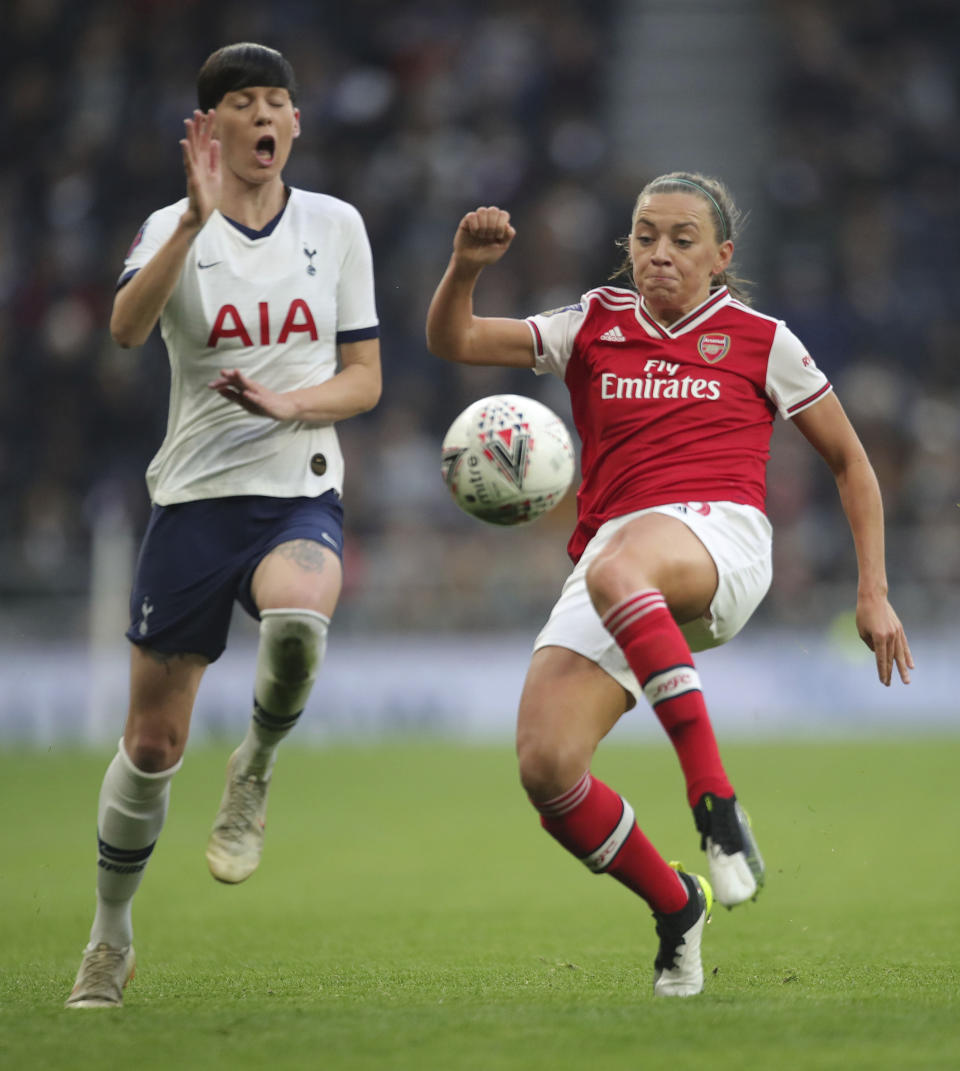 Tottenham Hotspur's Ashleigh Neville, left, and Arsenal's Katie Mccabe battle for the ball during their Women's Super League soccer match at the Tottenham Hotspur Stadium in London, Sunday Nov. 17, 2019. The match drew a record crowd of 38,262 for the competition on Sunday when Arsenal claimed a 2-0 victory at Tottenham. (Zac Goodwin/PA via AP)