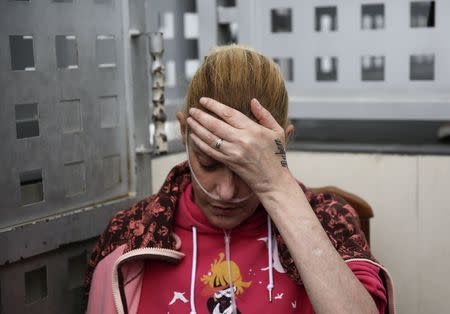 Raquel Mejias, 39, who is HIV positive and has one lung, waits before learning that her eviction was suspended in Madrid, in this October 2, 2014 file photo. REUTERS/Andrea Comas/Files