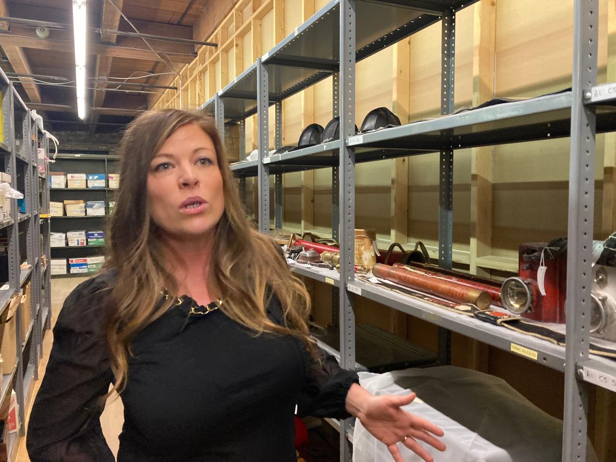 History Museum Executive Director Kristi Scott gives a tour of the facility's storage area which will undergo renovations in the coming months.