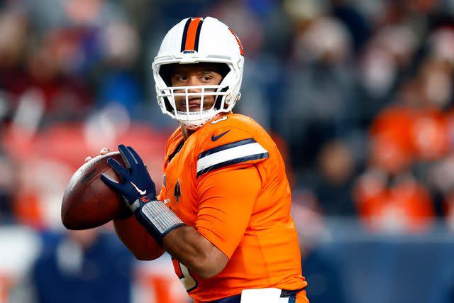 <p>Justin Edmonds/Getty</p> Russell Wilson of the Denver Broncos passing during the first quarter of the game against the New England Patriots in December 2023