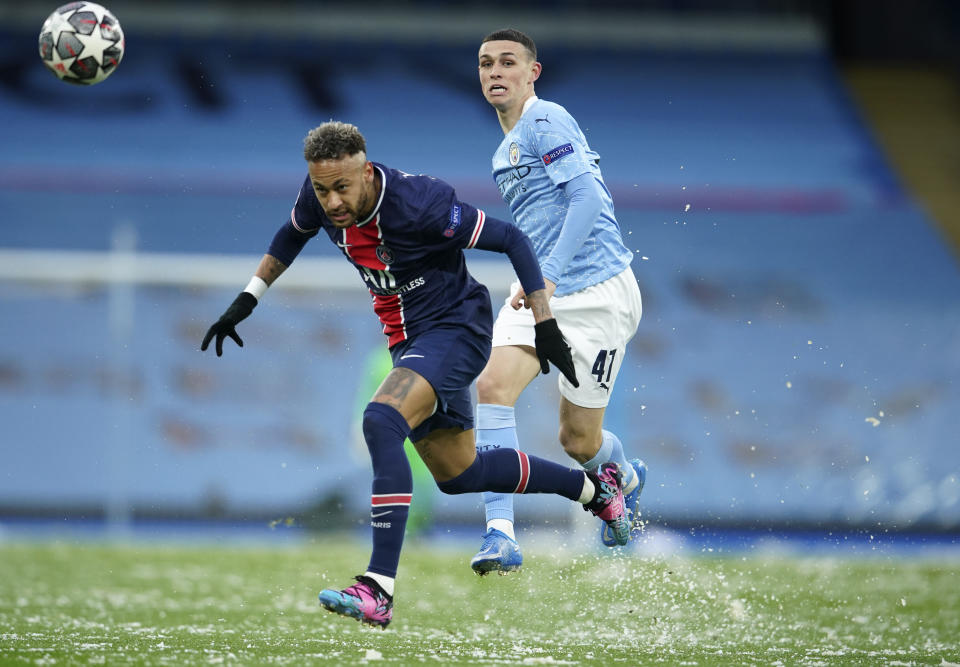 Manchester City's Phil Foden, right, challenges PSG's Neymar during the Champions League semifinal second leg soccer match between Manchester City and Paris Saint Germain at the Etihad stadium, in Manchester, Tuesday, May 4, 2021. (AP Photo/Dave Thompson)