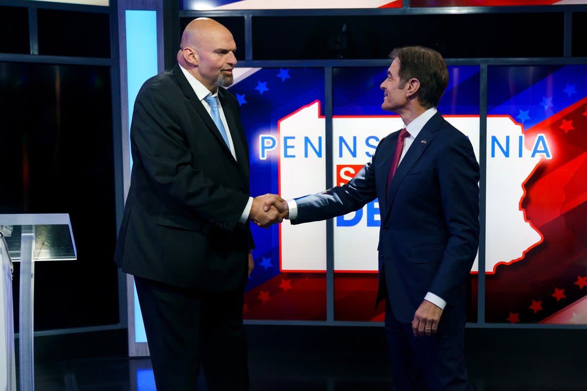A handout photo made available by ABC27 shows Democratic candidate Lt. Gov. John Fetterman (left) and Republican Pennsylvania Senate candidate Dr Mehmet Oz (right) shaking hands prior to the Nexstar Pennsylvania Senate Debate at WHTM ABC27 in Harrisburg, Pennsylvania, USA, 25 October 2022 (EPA)