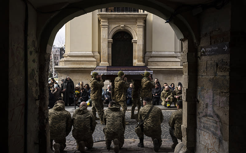 Military servicemen carry the coffin of 42-year-old soldier Andrii Bontsiun during a funeral ceremony