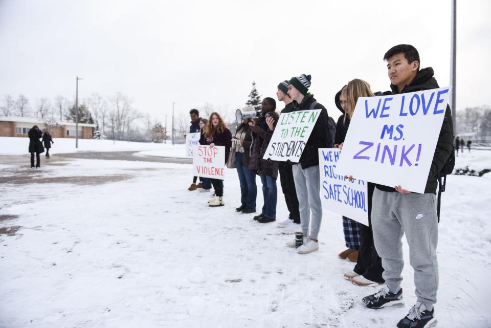 Students at East Lansing High School gather in front of the school following a walkout to raise their voices against school violence, Thursday, Jan. 26, 2023.