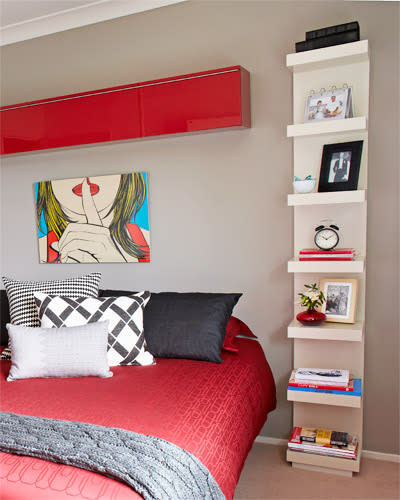 Think vertically, adding shelving to walls and possibly extending them to the ceiling. This a particularly good idea if your bedroom is small, and open shelving close to the bed holds way more than two bedside tables.